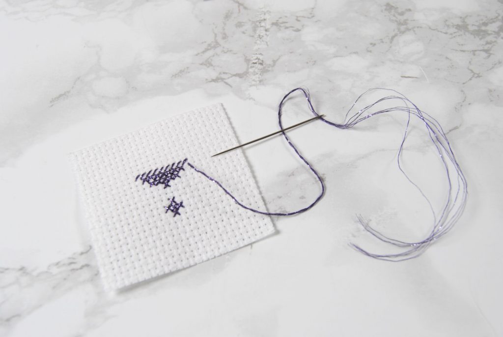 A partially cross stitched heart in Lecien Nishikiito thread.