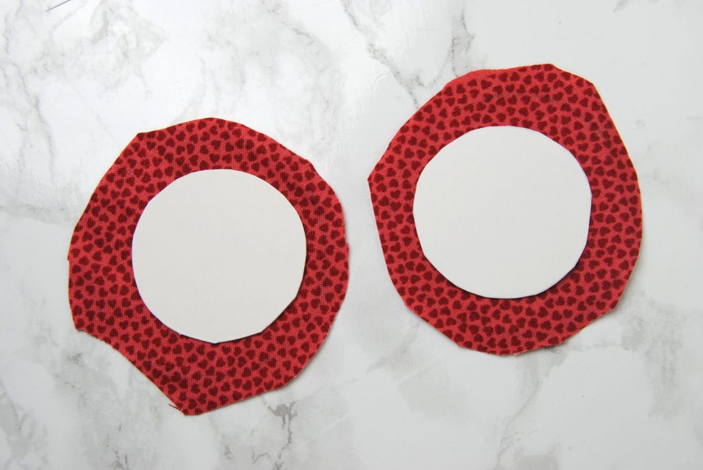 Cut fabric circles a bit larger than your matboard