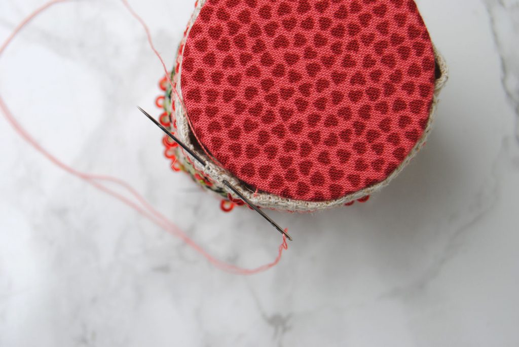 Use a ladder stitch to attach the bottom to your pin drum.