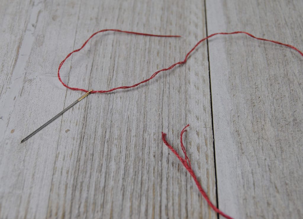 A threaded tapestry needle showing that only two strands are used at a time.