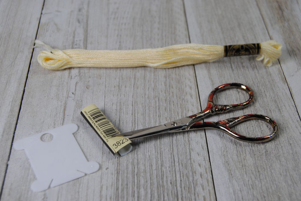 Cutting the number out of a skein label.