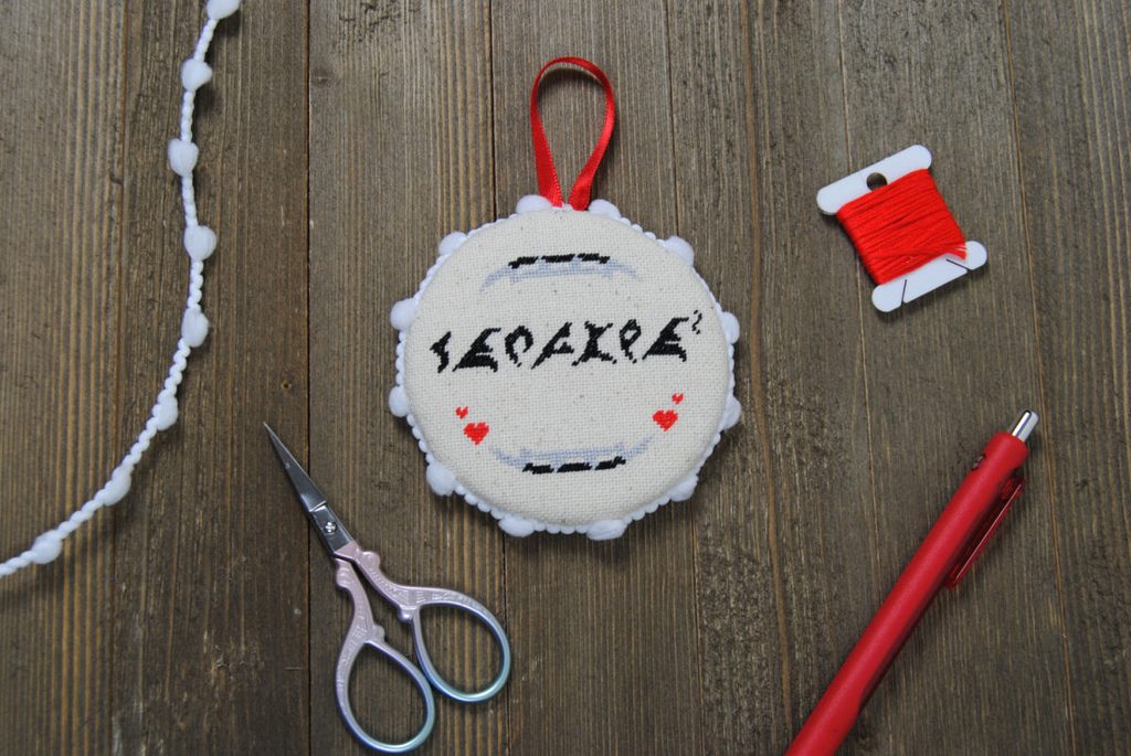 A Klingon themed cross stitch finished as a flat ornament.