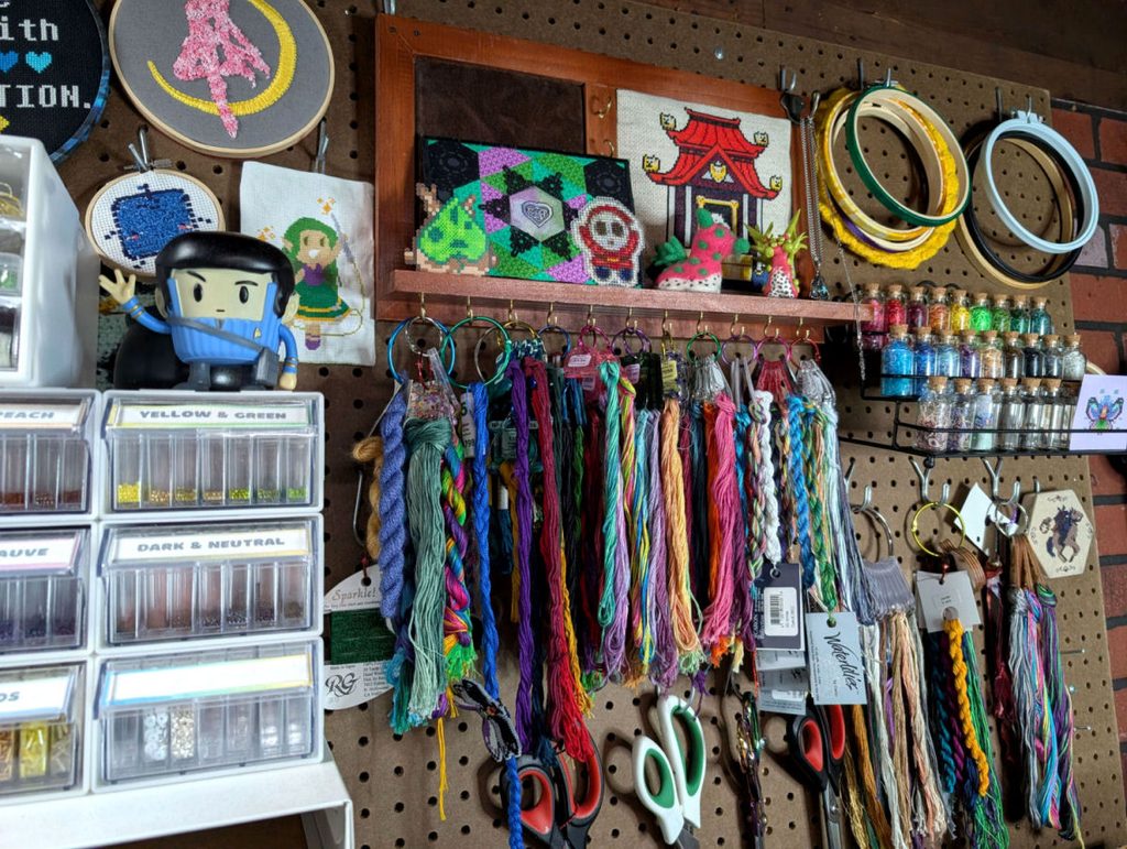 A jewelry organizer holding embroidery thread on floss drops.