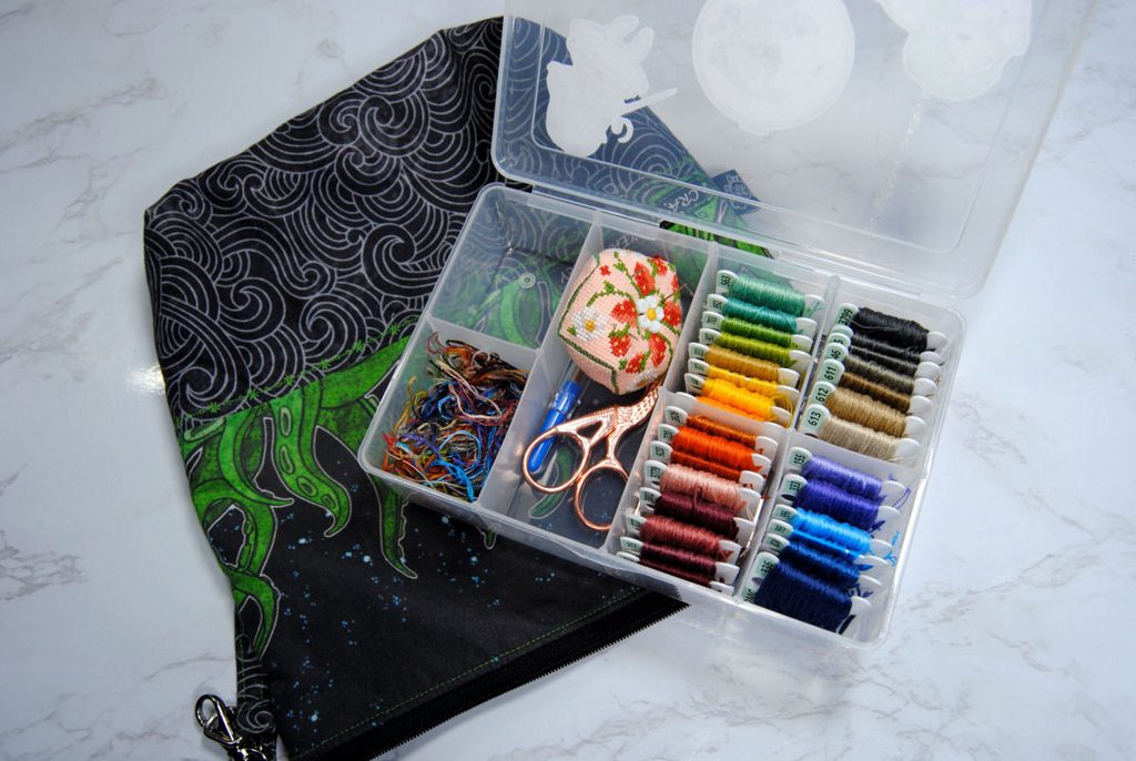 A small travel bobbin box full of embroidery thread.