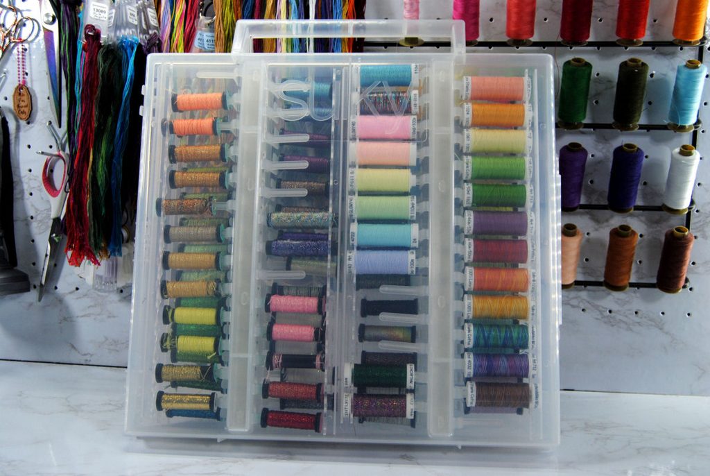 A large plastic box designed to hold thread on thin spools.