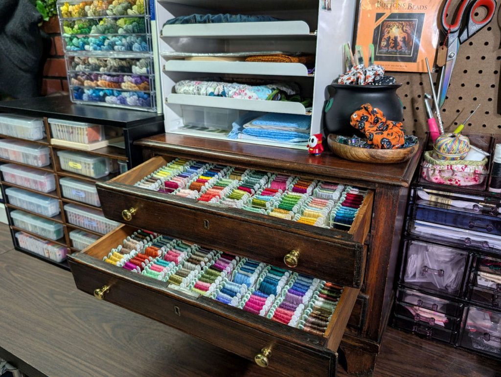 Wooden drawers full of dmc thread on bobbins
