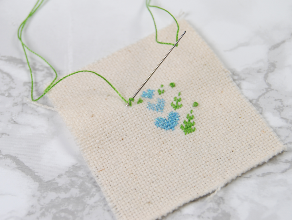 A partially stitched project, demonstrating a french knot using Cotton Petites thread.