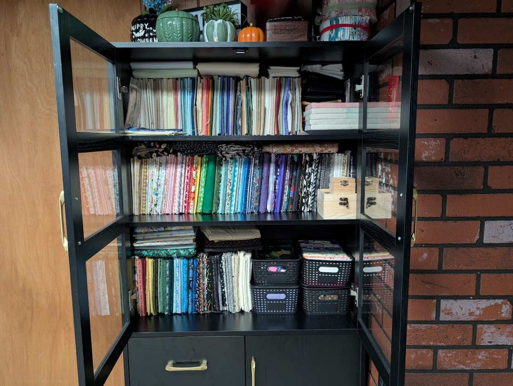 Fabric storage example featuring a glass-door cabinet and mini bolts.