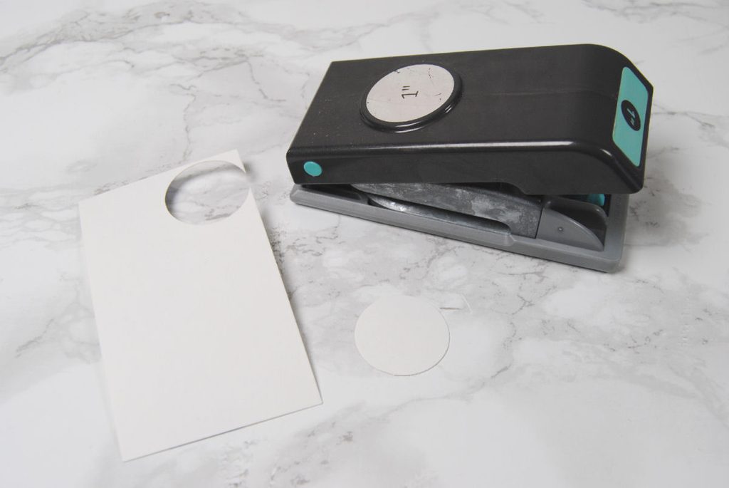 A one inch round hole punch used on cardstock.