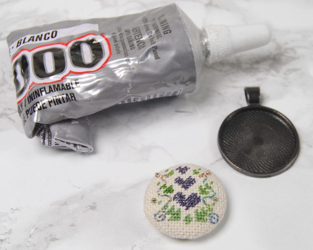 Materials for a cross stitch pendant tray