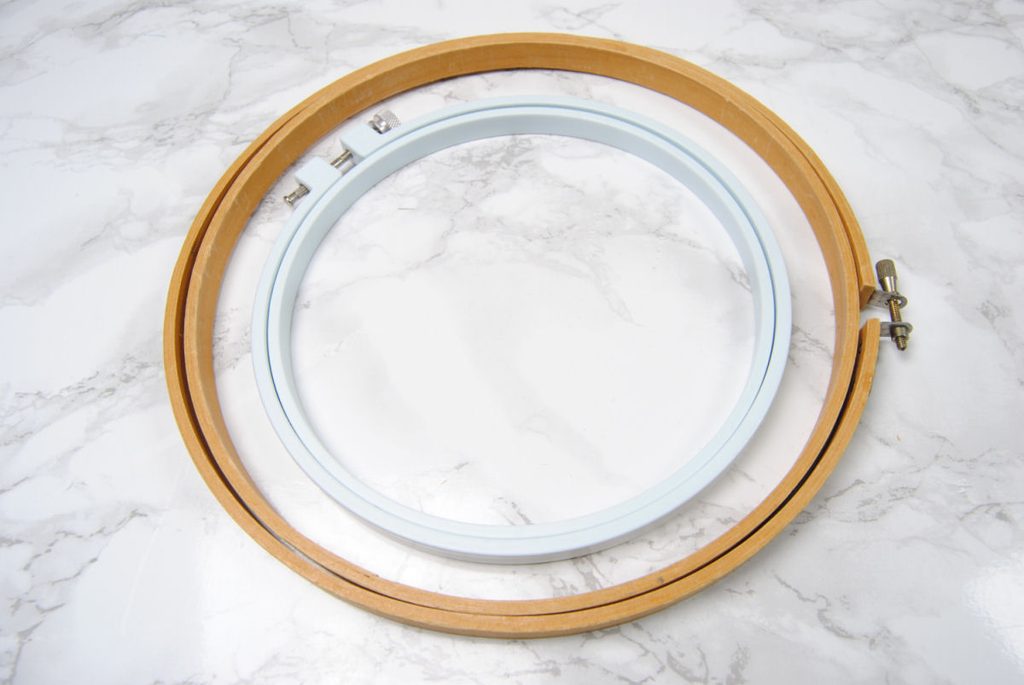 A wood and a plastic embroidery hoop in different sizes.