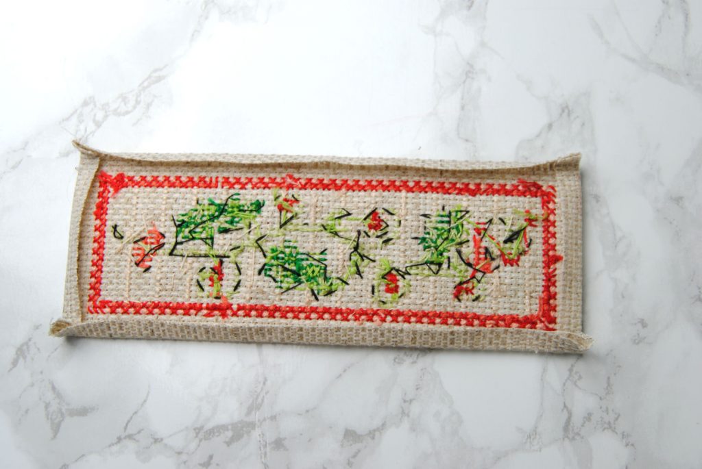 Folding the edges of your cross stitch.