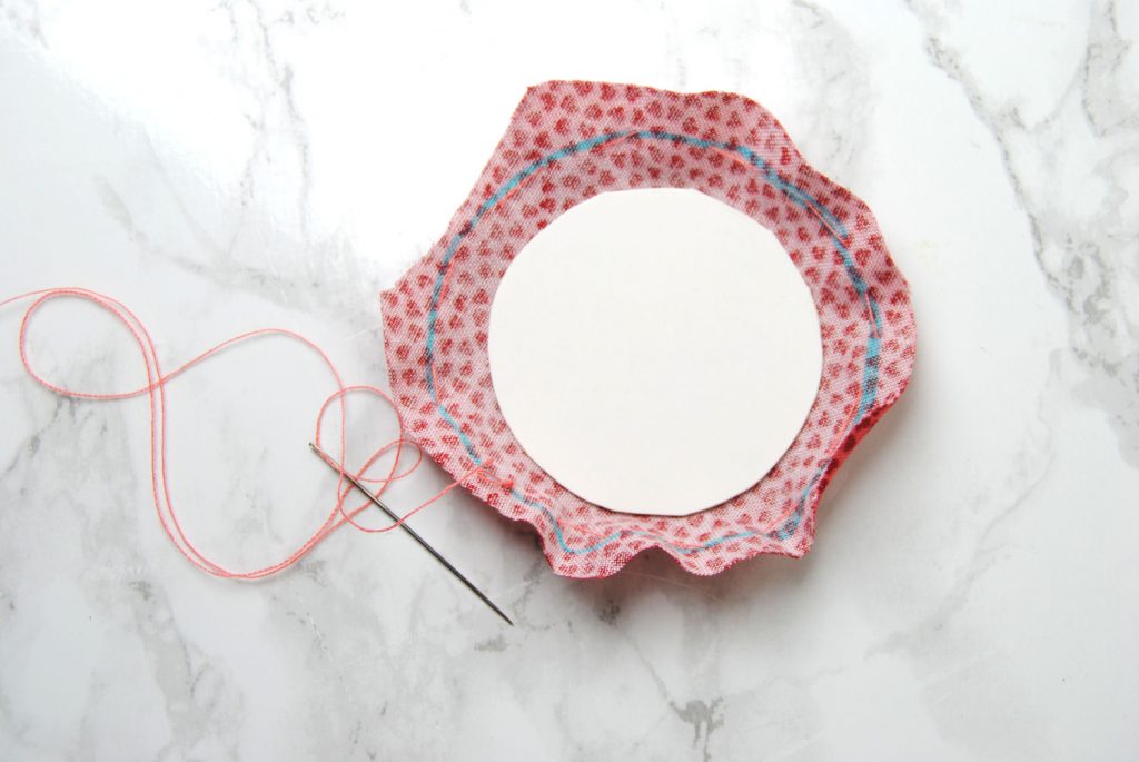 Running stitch along the edge of your fabric circle.