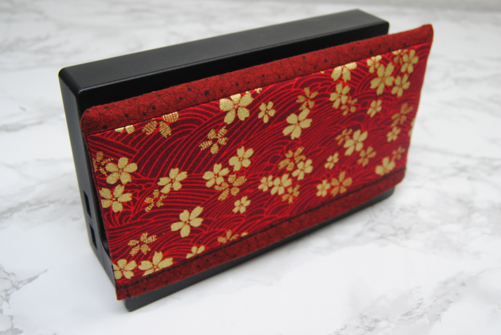 My first test switch dock cover ; featuring a red and gold oriental fabric.