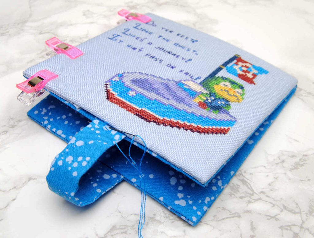 Ladder stitch around your cross stitch piece to secure.