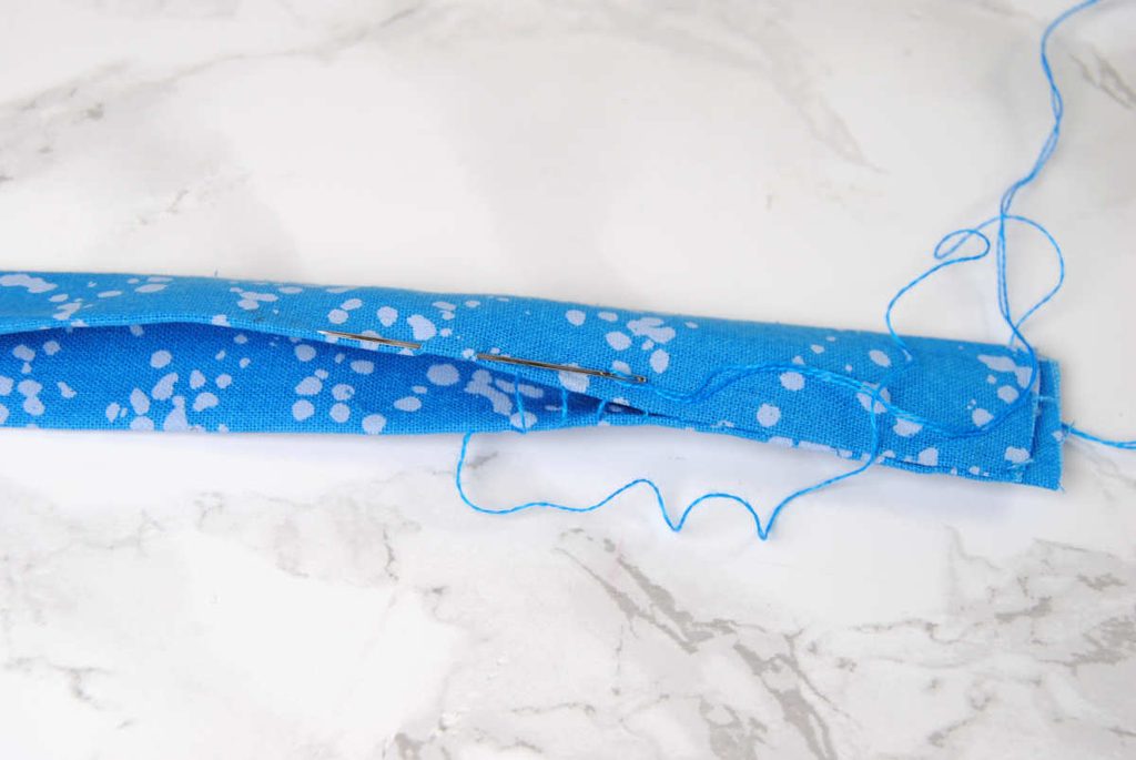 Sewing up the sides of our fabric strip using the ladder stitch.