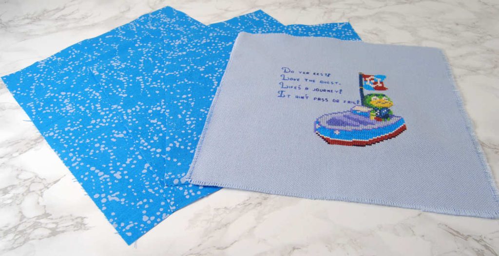 The fabric pieces required for a cross stitch flatfold finish.