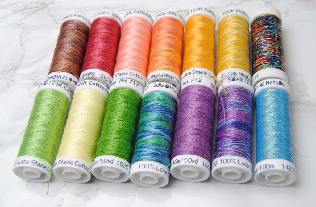 A 12-color palette of Sulky thread spools.