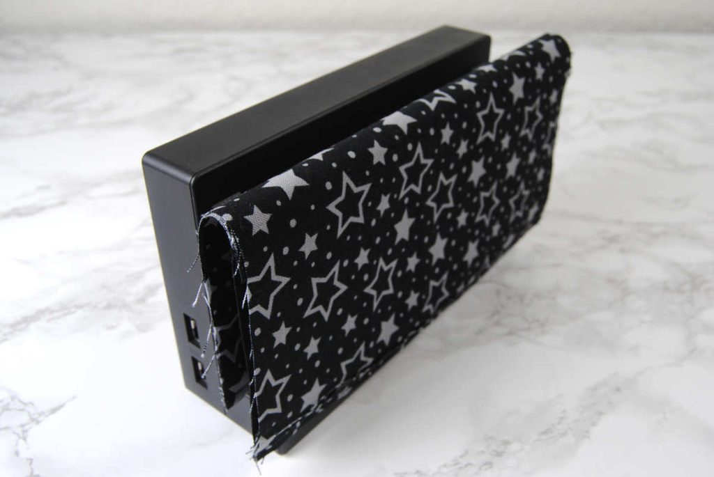 Draping fabric over a switch dock to test sizing.