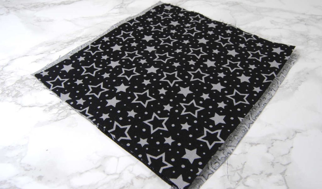 Layering inner lining fabric on top of outer fabric.