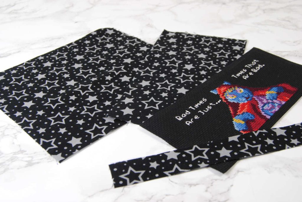Materials necessary for making a cross stitch panel switch dock cover.