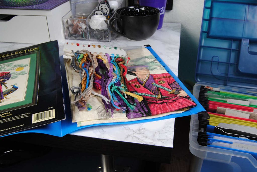 An in progress Mighty Samurai Dimensions kit stored in a hanging file folder.