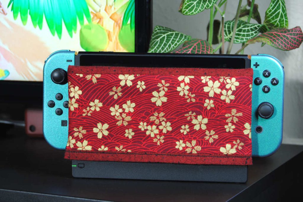 A fabric switch dock cover using red and gold fabrics.
