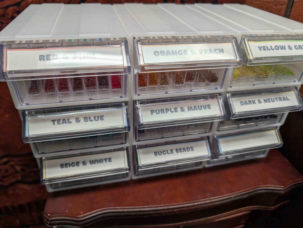 Modular bead storage containers sorted by color.