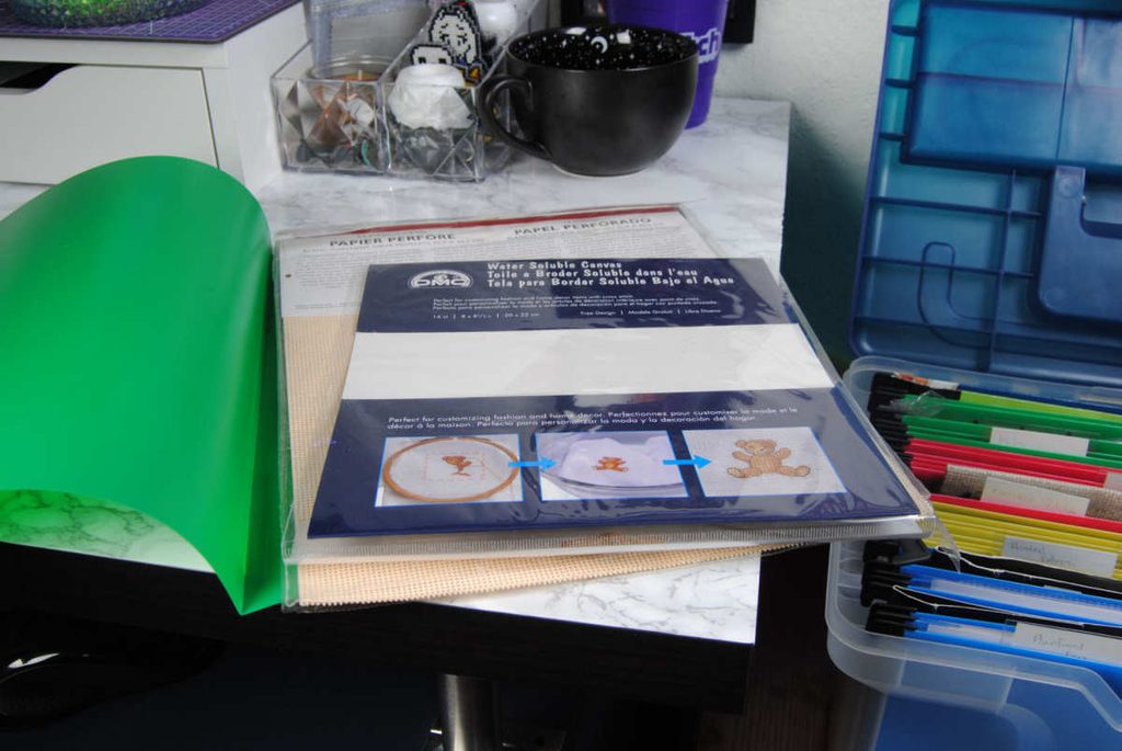 Water soluble canvas and perforated paper stored in a hanging file folder.