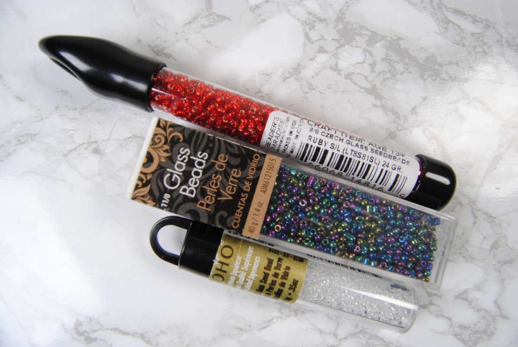 Examples of different brands and packaging styles of seed beads.