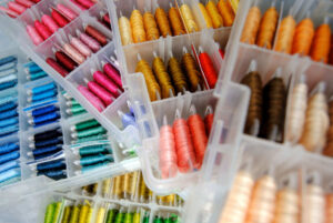 Colorful boxes of embroidery thread on bobbins