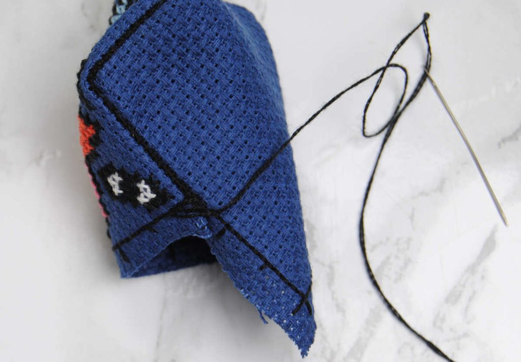 Demonstrating a lattice of stitches before cinching them tight.