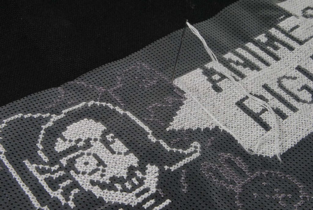 Stitching into soluble canvas by making sure your needle is straight and you're not stitching at an angle.