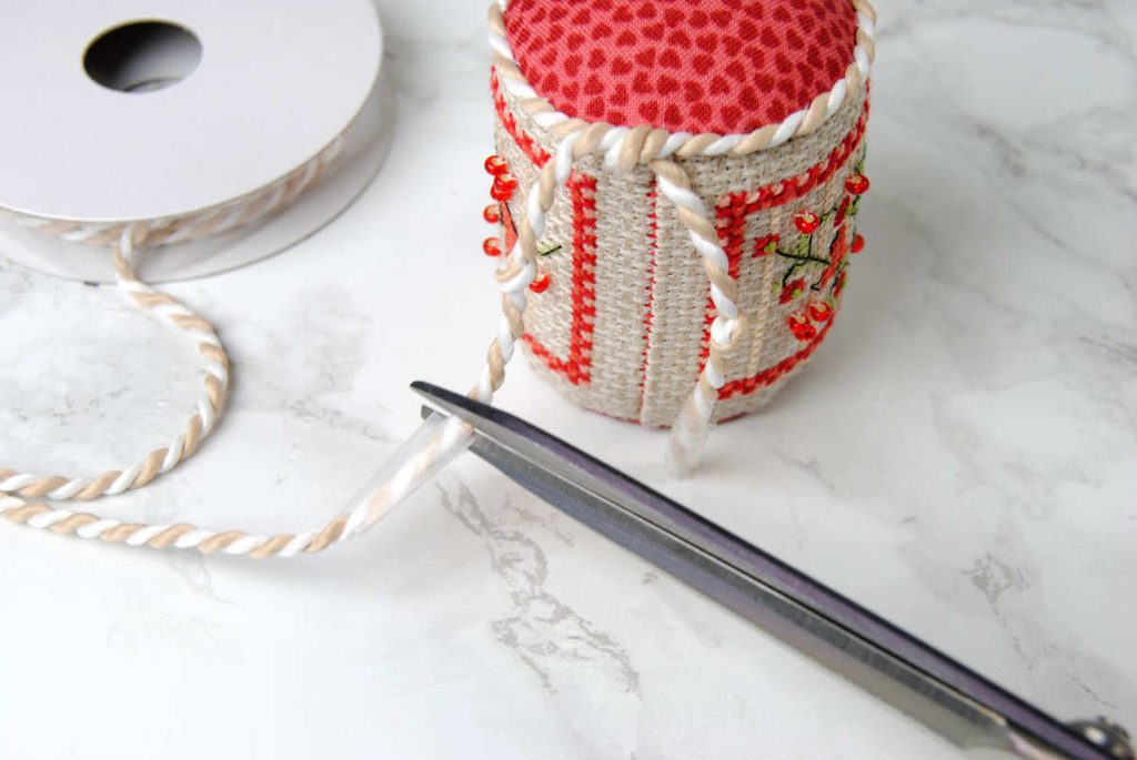 Trimming braided cording to desired length.
