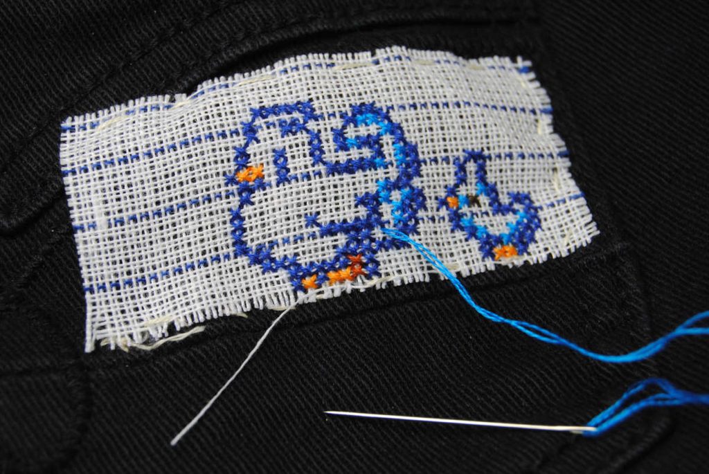 Waste canvas fraying along the edges around the cross stitches.
