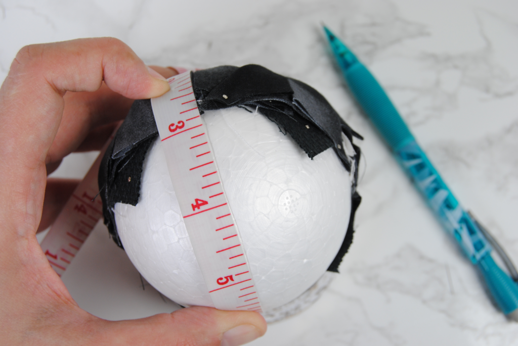 Measuring the circumference of your foam ball to determine the center.