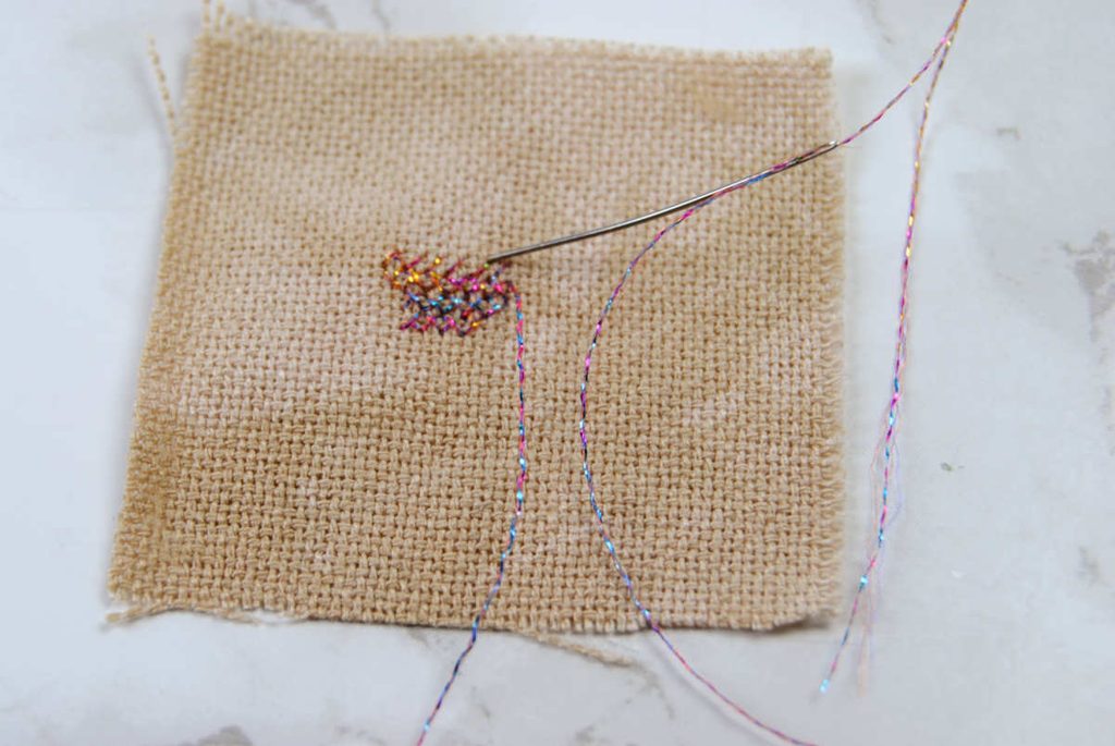 Closeup of Accentuate thread being cross stitched.