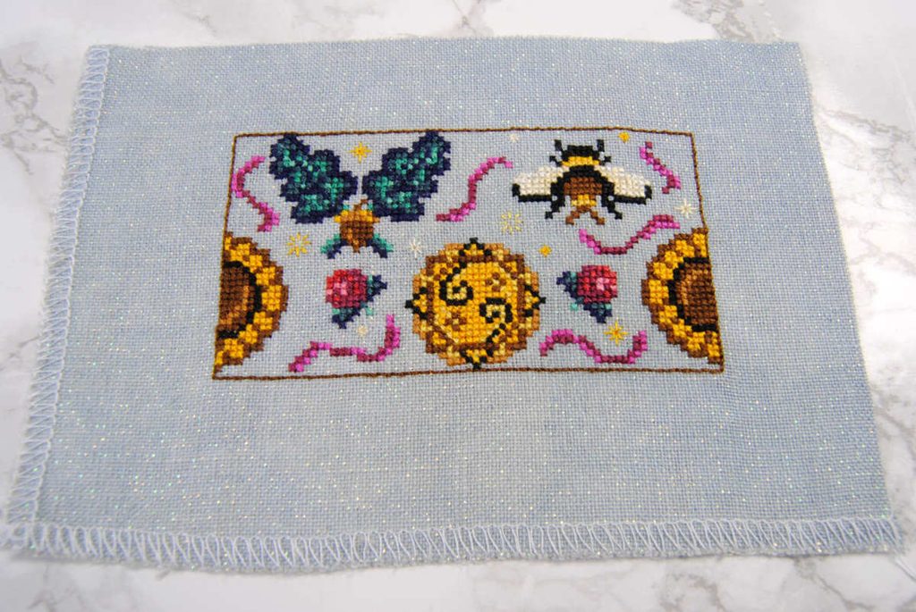 Flat view of a cross stitched summer humbug before assembly.