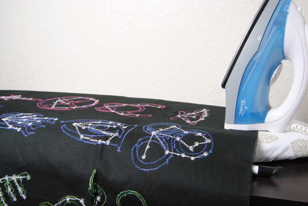 Ironing my finished cross stitch in preparation for stretching.