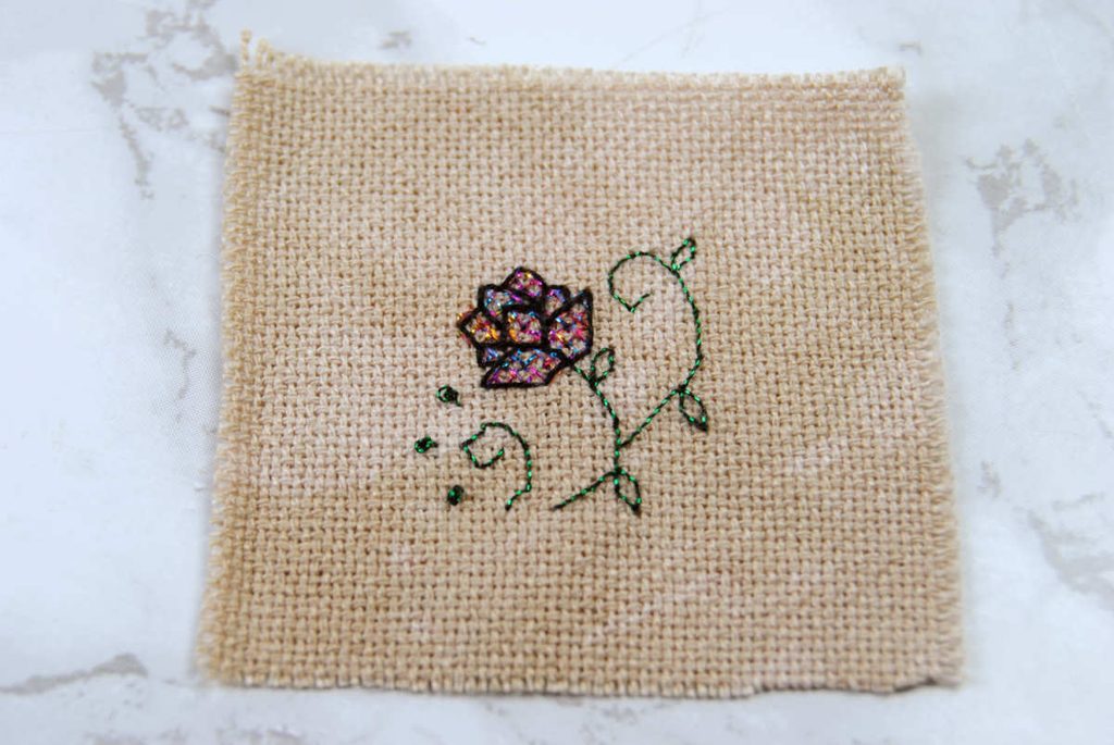 Cross stitched lotus flower design on evenweave fabric.