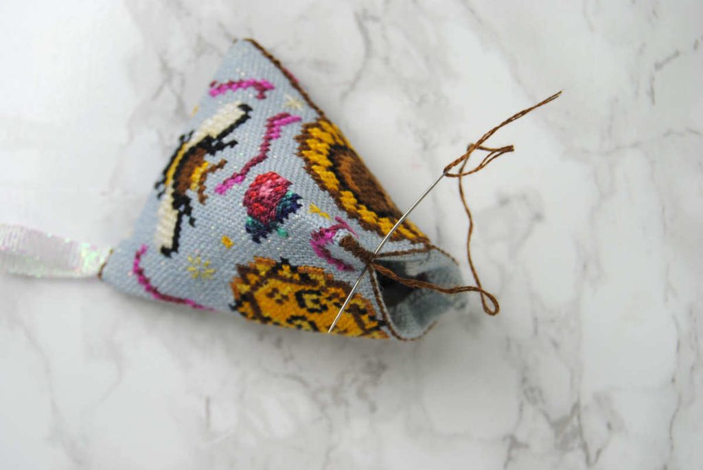Starting to stitch together the last side of your humbug.