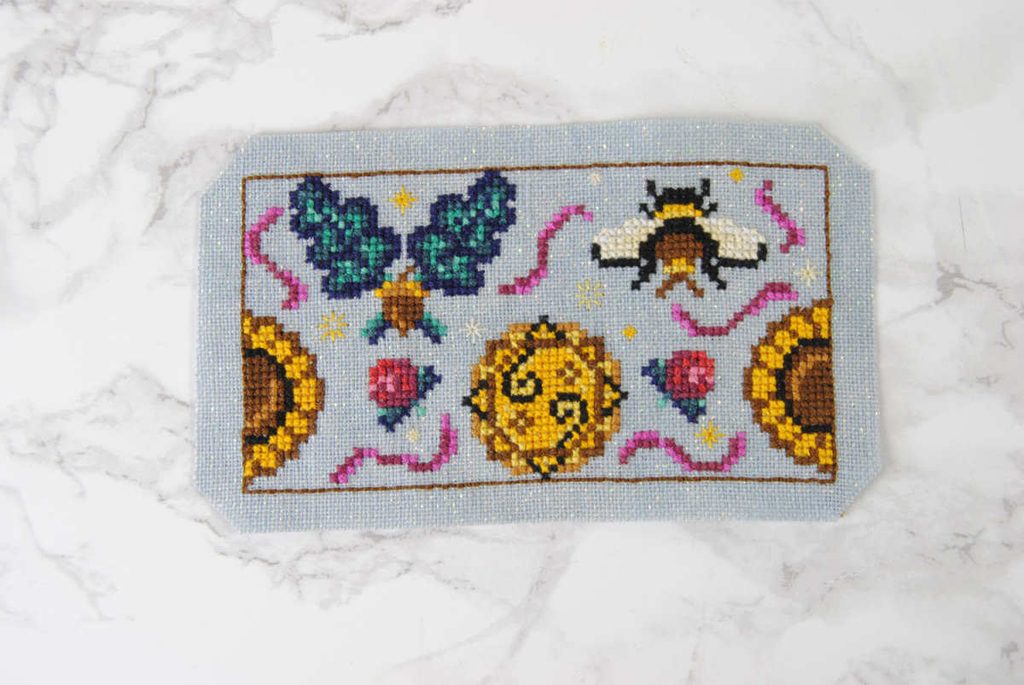 Trim your fabric a few stitches away from the backstitch. Trim the corners off if wanted.