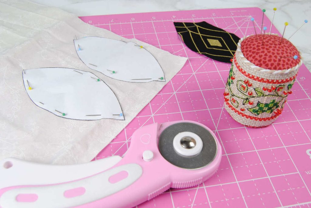 Lens templates pinned to fabric ready to be cut.