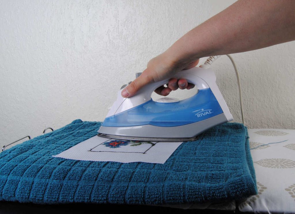 Ironing a cross stitch project face down on a towel
