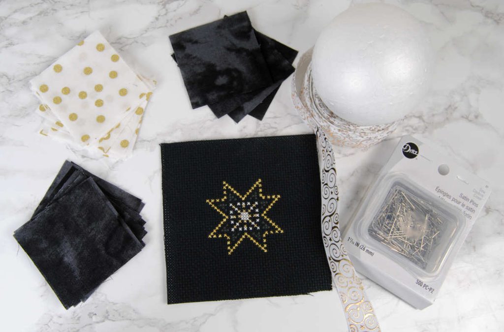 Materials (listed below) for quilted ornament all laid out.
