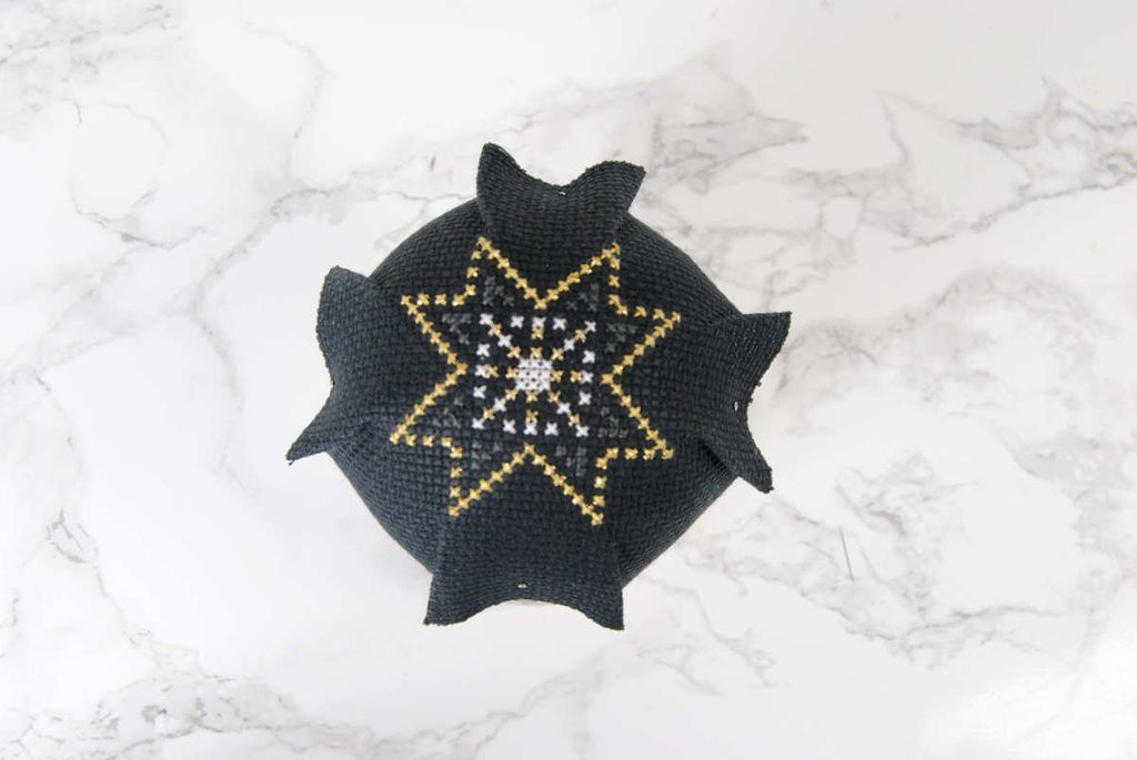 Pin down your cross stitch in the corners.