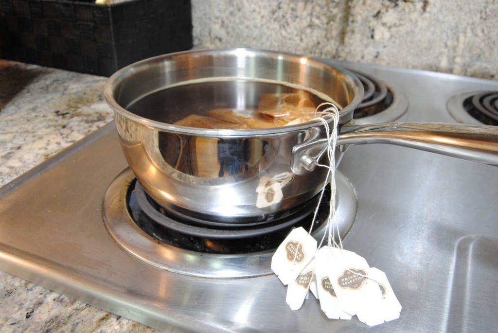 Boiling black tea on the stove.