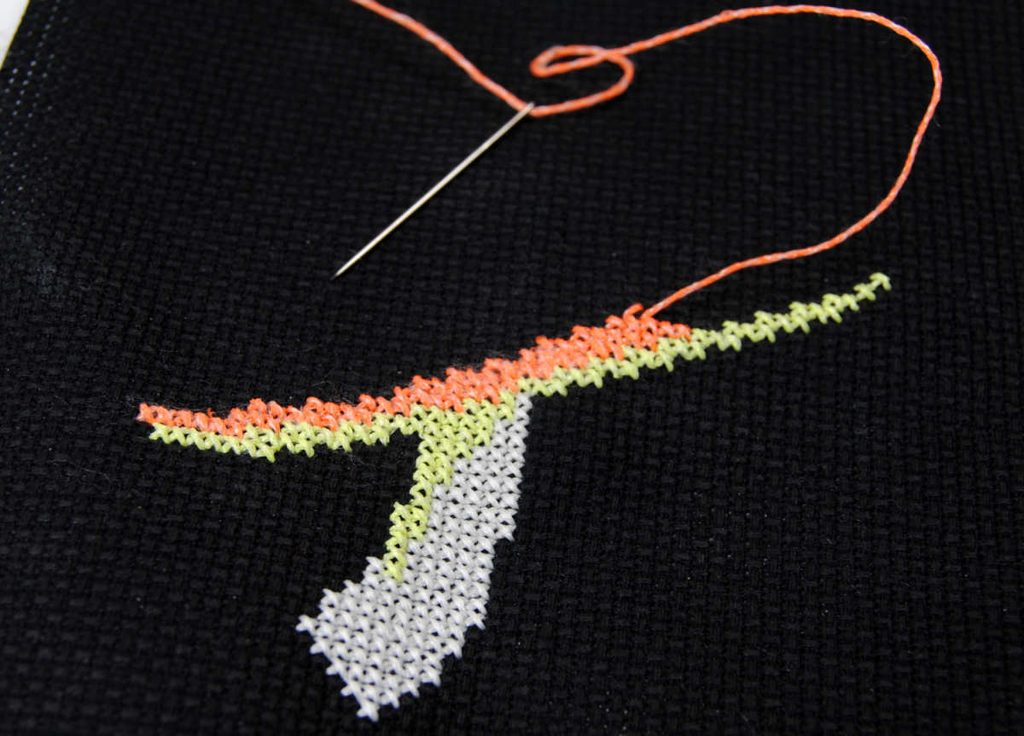 Demonstration of stitching with orange kreinik #8 glow in the dark thread. 