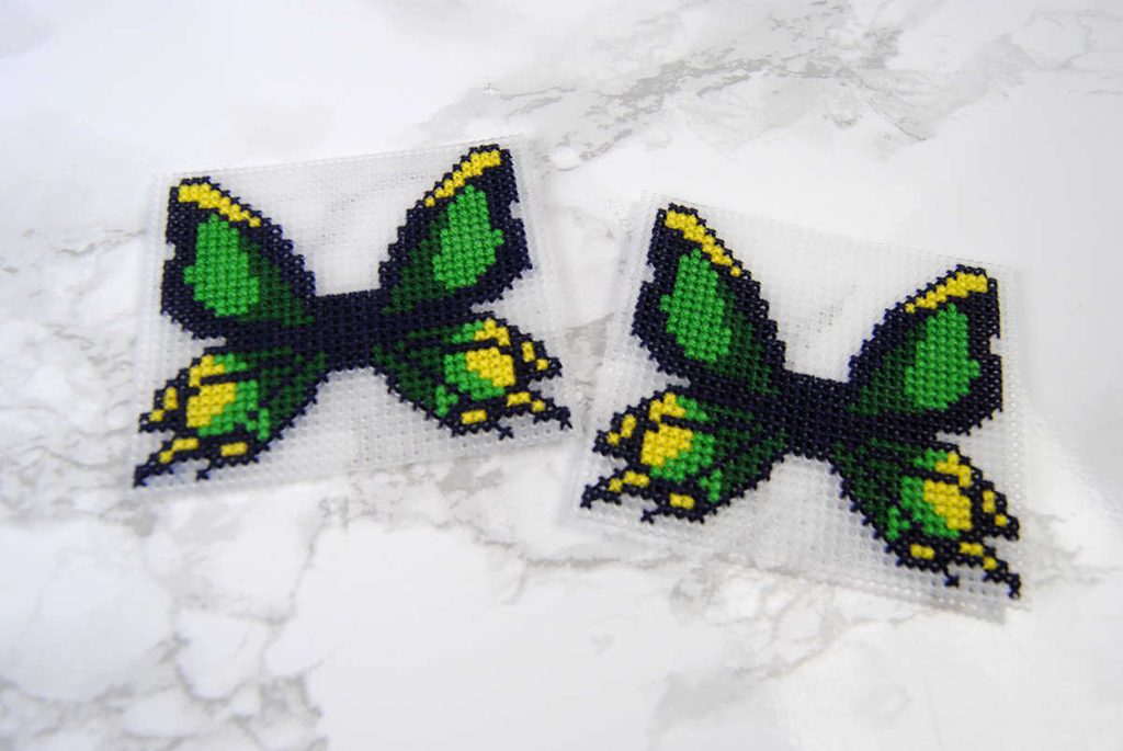 Two cross stitched thunderwing butterflies on plastic canvas
