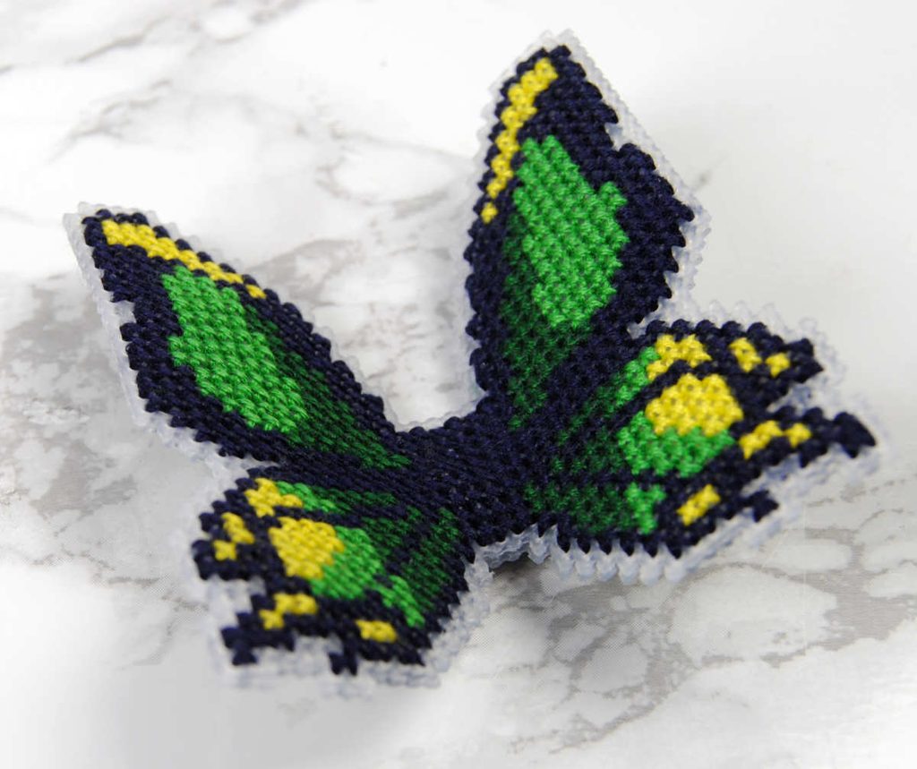 Posing a wired cross stitch butterfly in a way that makes it 3D.